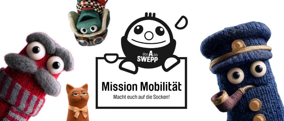 Vier bunte Sockenfiguren aus Mission Mobilit&auml;t: eine blaue Figur mit M&uuml;tze und Pfeife, eine graue mit rotem Schal, eine gr&uuml;ne mit Fliegerbrille und eine orangefarbene mit Schleife.