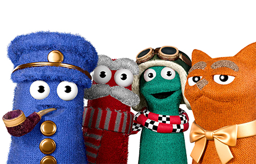 Vier bunte Sockenfiguren aus Mission Mobilit&auml;t: eine blaue Figur mit M&uuml;tze und Pfeife, eine graue mit rotem Schal, eine gr&uuml;ne mit Fliegerbrille und eine orangefarbene mit Schleife.